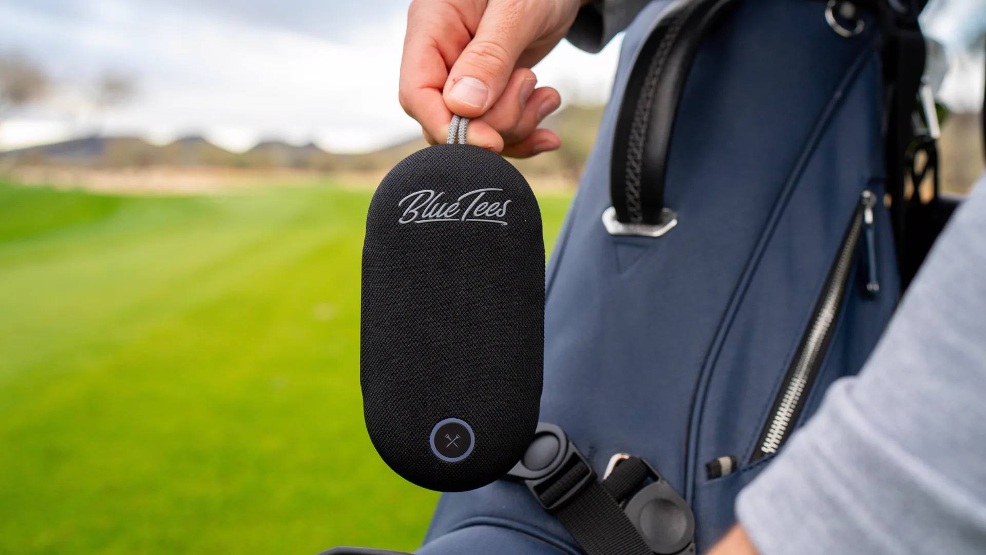 PlayerGo speaker hanging from a golf bag on the course