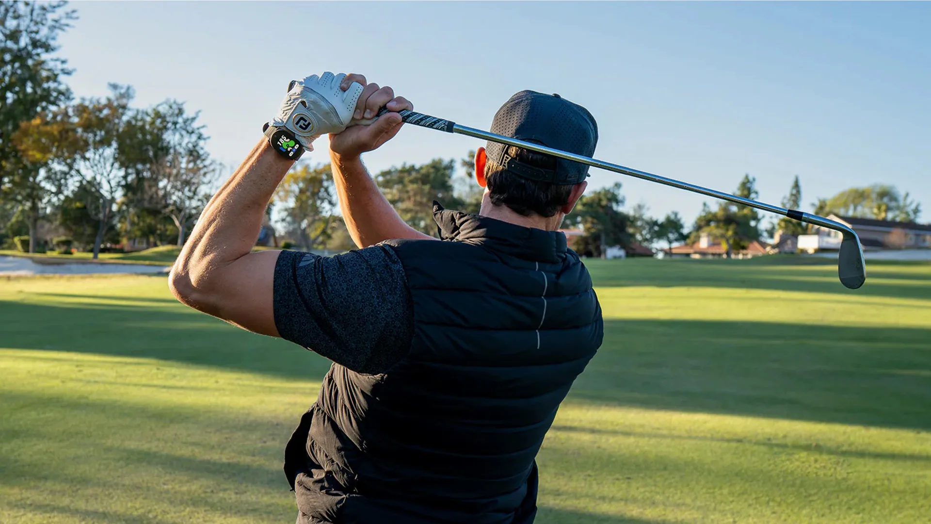 Golfer mid-swing wearing the PlayMaker+