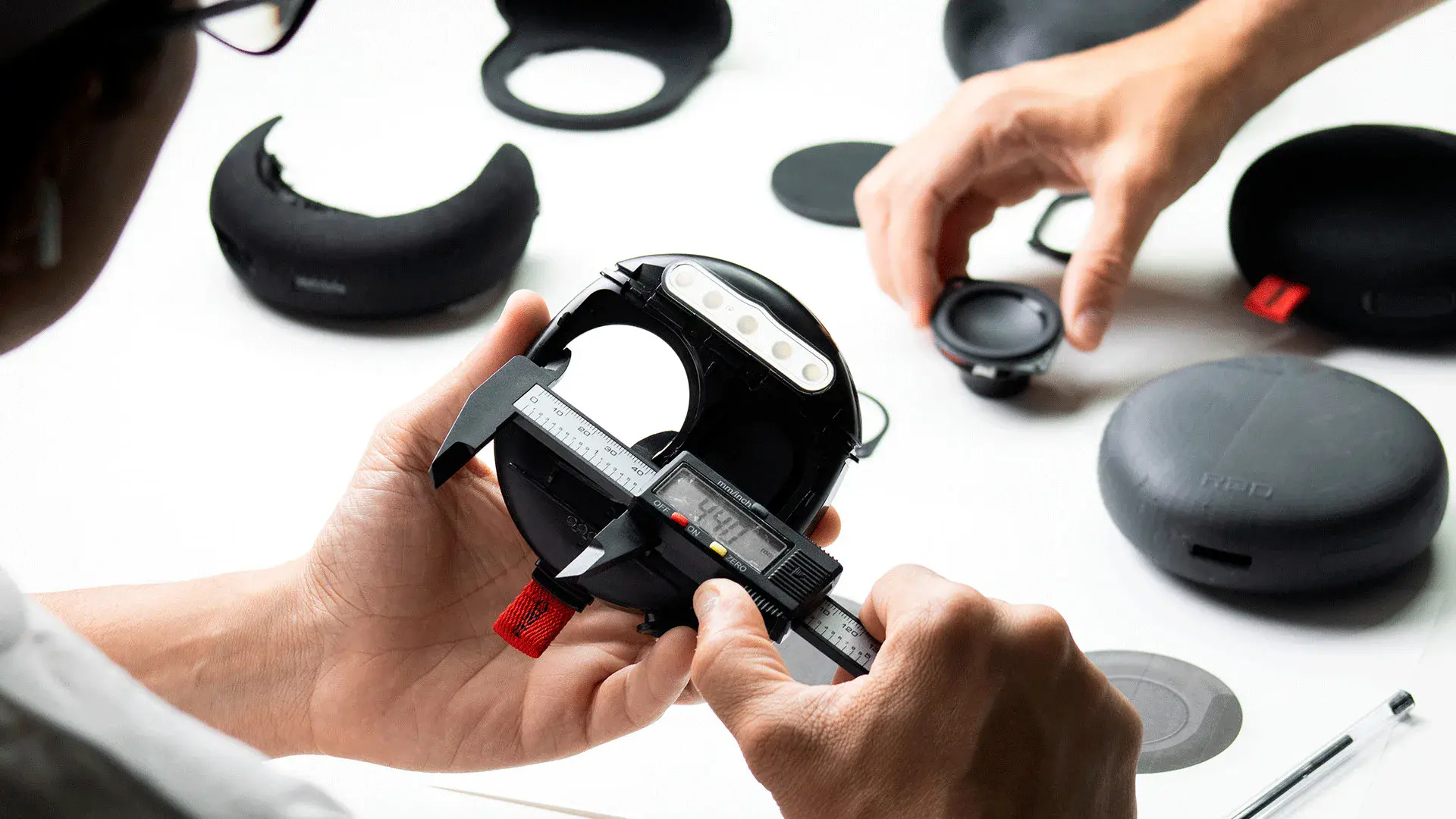 Hands assembling Rad Sound speaker components on a workbench